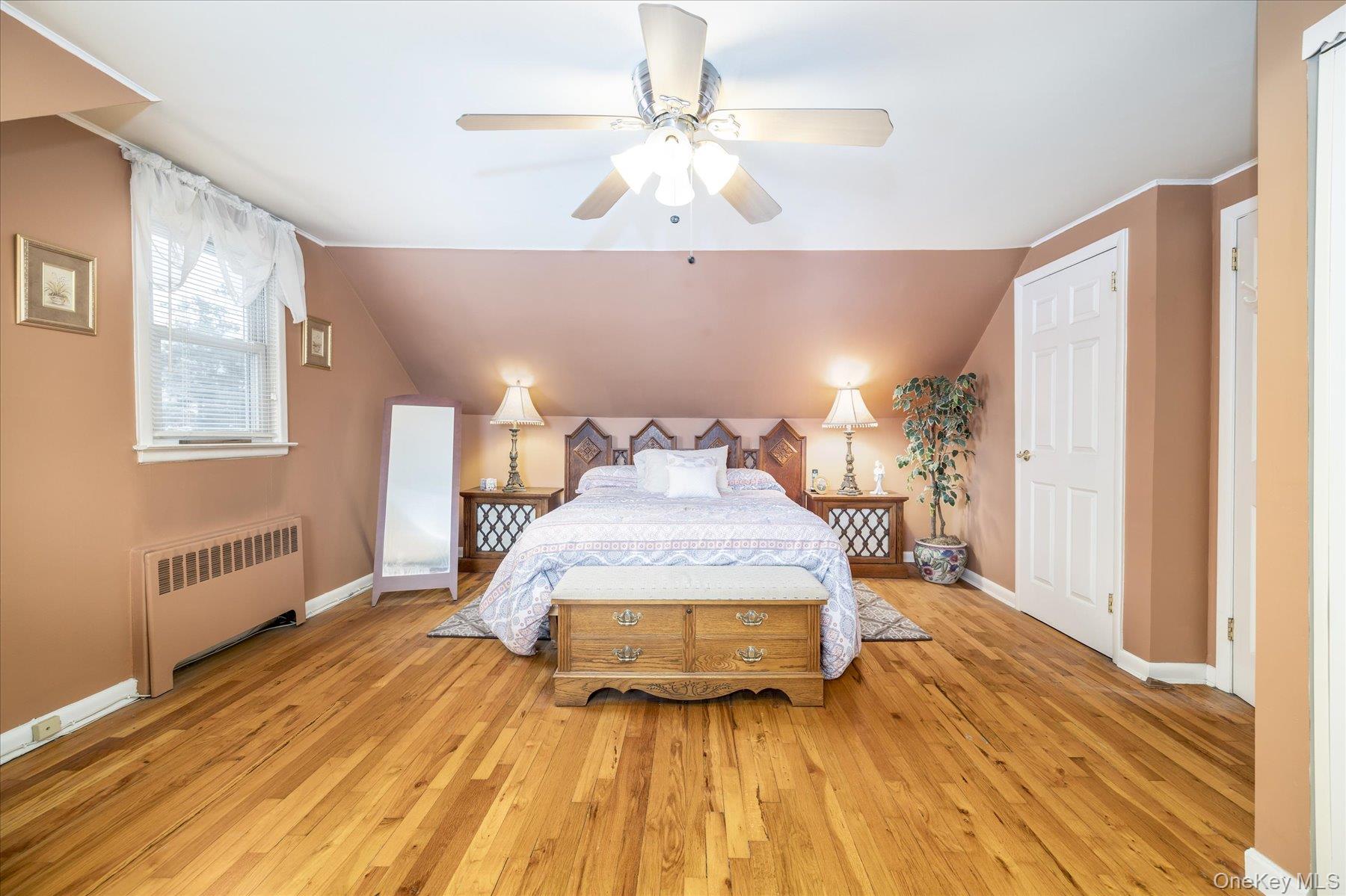 158 Roosevelt Avenue Freeport, NY 11520 - Photo 10 of 30 a spacious bedroom with a bed and wooden floor