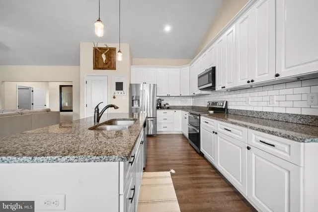 a living room with furniture and a mirror