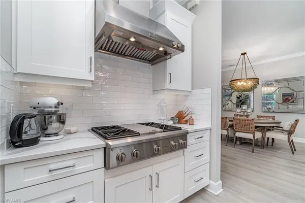 a kitchen with a stove and cabinets
