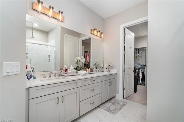 a bathroom with a sink vanity and mirror
