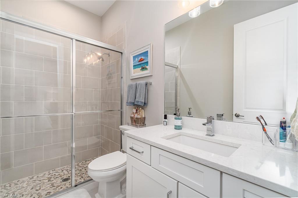 9536 Montelanico Loop Naples, FL 34119 - Photo 16 of 24 a bathroom with a sink toilet and shower