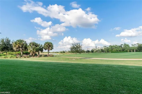 a view of a golf course with a lake view