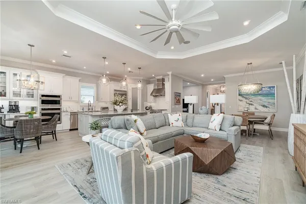 a living room with furniture kitchen view and a table