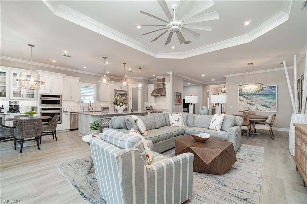 9536 Montelanico Loop Naples, FL 34119 - Photo 4 of 24 a living room with furniture kitchen view and a table