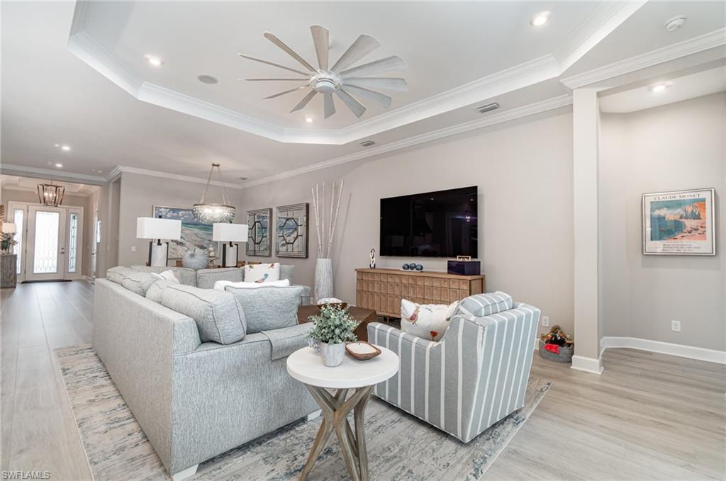 9536 Montelanico Loop Naples, FL 34119 - Photo 5 of 24 a living room with furniture and a flat screen tv