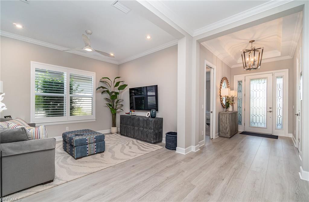 9536 Montelanico Loop Naples, FL 34119 - Photo 6 of 24 a living room with furniture and a flat screen tv