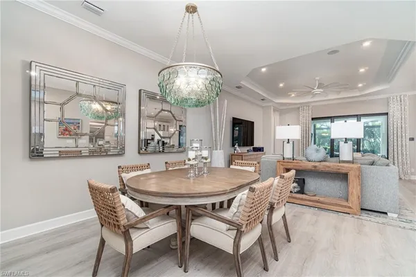 a view of a dining room with furniture wooden floor and chandelier
