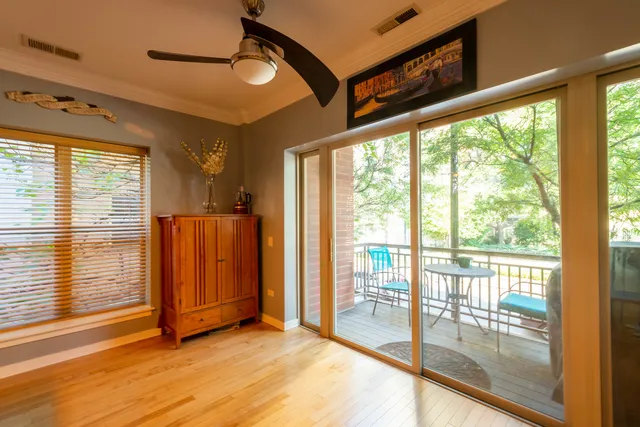 a view of a room with wooden floor and furniture