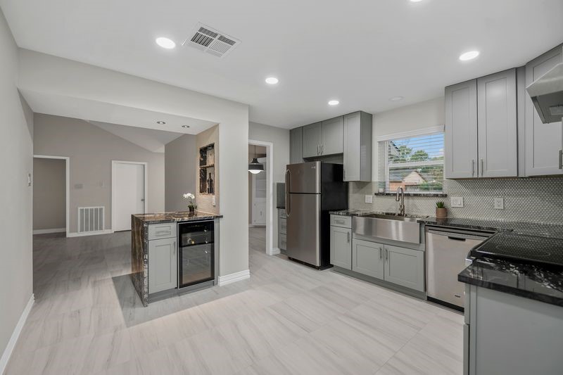 16519 Gaeldom Drive Houston, TX 77084 - Photo 11 of 28 a kitchen with stainless steel appliances granite countertop a refrigerator and a stove top oven