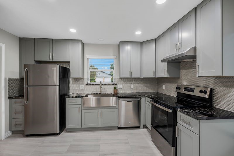 16519 Gaeldom Drive Houston, TX 77084 - Photo 12 of 28 a kitchen with stainless steel appliances granite countertop a stove a refrigerator and a refrigerator