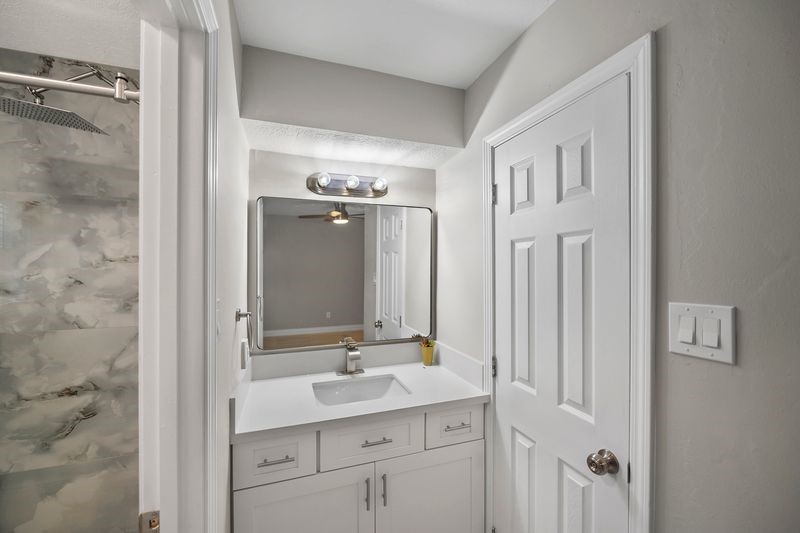 16519 Gaeldom Drive Houston, TX 77084 - Photo 19 of 28 a bathroom with a double vanity sink a mirror and a