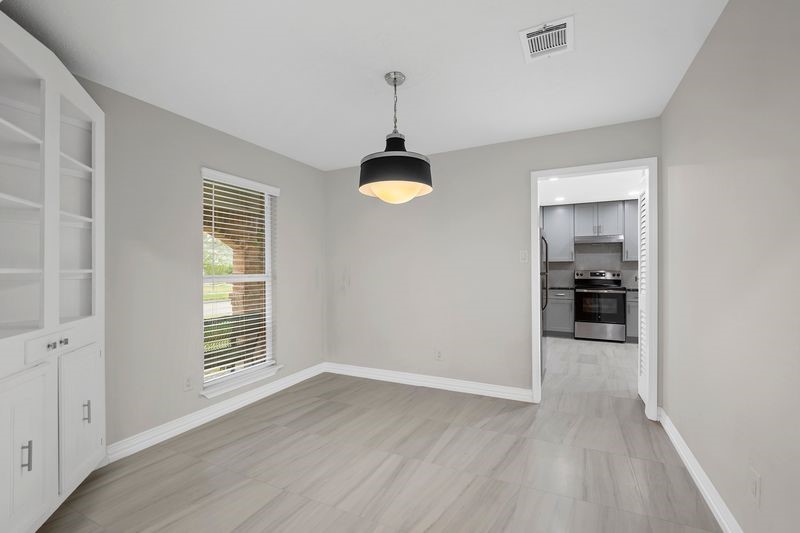 16519 Gaeldom Drive Houston, TX 77084 - Photo 7 of 28 wooden floor in an empty room with a window