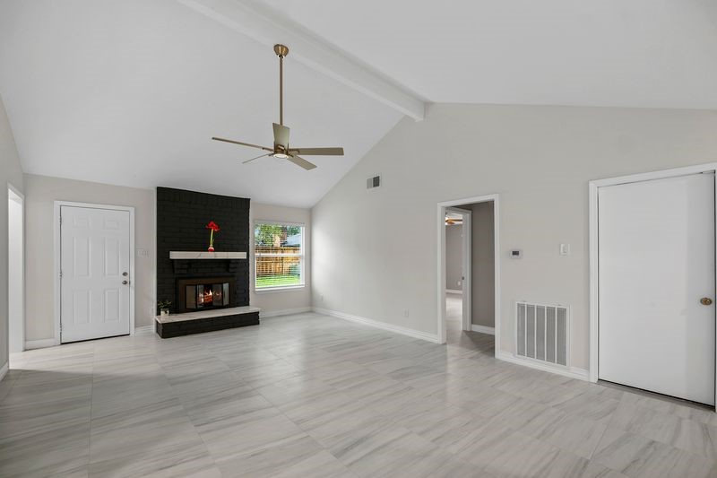 16519 Gaeldom Drive Houston, TX 77084 - Photo 8 of 28 a view of a livingroom with a flat screen tv and a fireplace