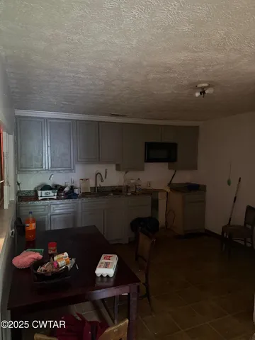 a kitchen with a table chairs stove and cabinets