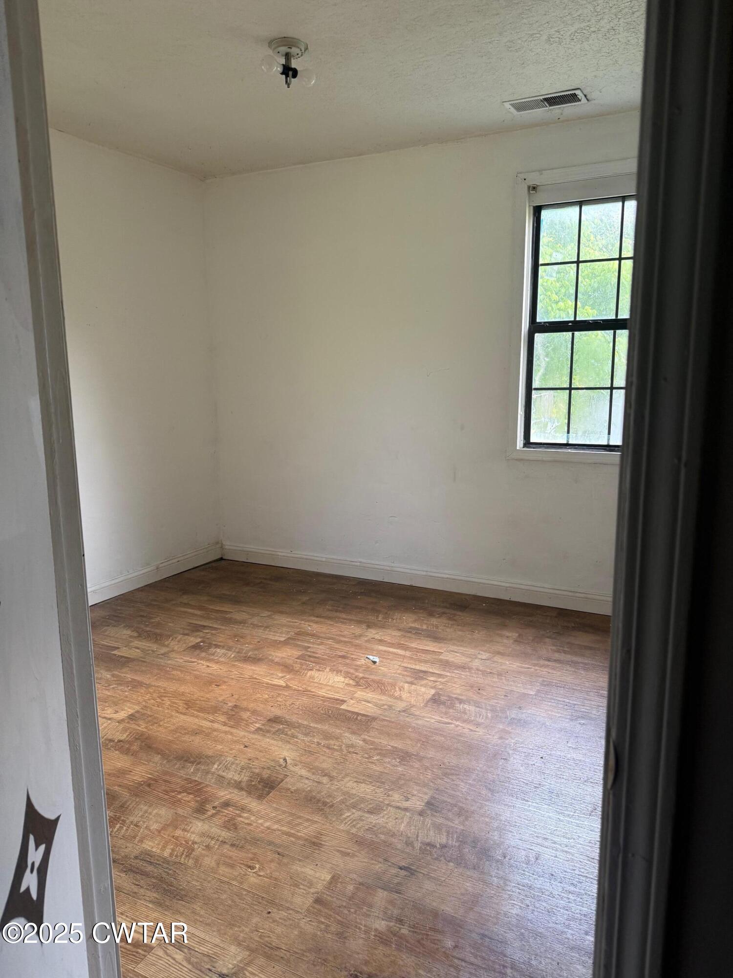 19 Loop Road Jackson, TN 38301 - Photo 7 of 9 an empty room with a window
