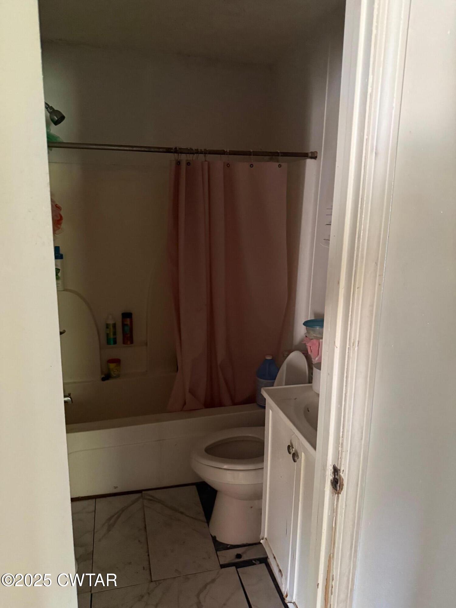 19 Loop Road Jackson, TN 38301 - Photo 8 of 9 a bathroom with a sink a toilet a window and shower