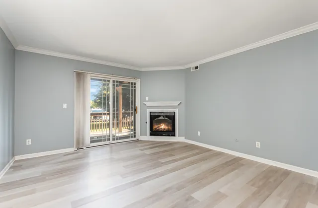wooden floor fireplace and windows in a room