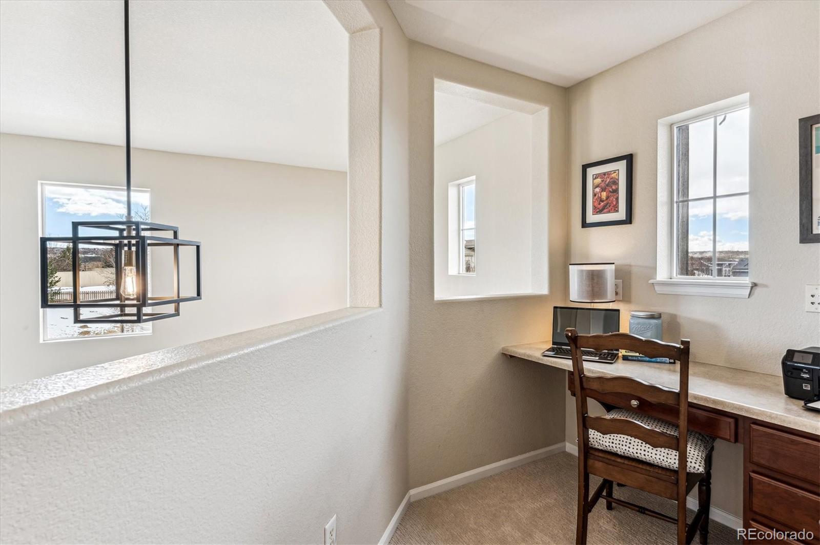 10904 Brooklawn Road Highlands Ranch, CO 80130 - Photo 25 of 50 a view of a workspace with furniture and a window