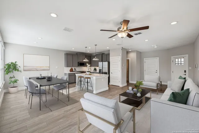 a living room with fireplace furniture and a wooden floor