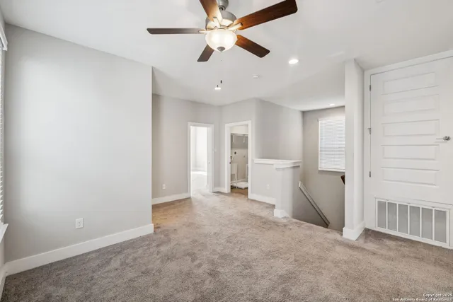 wooden floor in an empty room and a ceiling fan