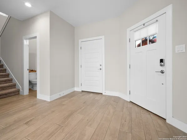 a view of an empty room with wooden floor