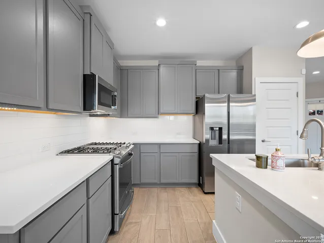 a kitchen with a sink stove and refrigerator