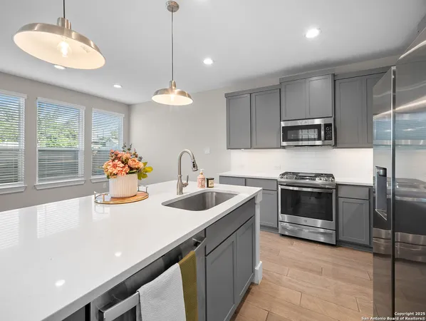 a kitchen with sink a stove and refrigerator