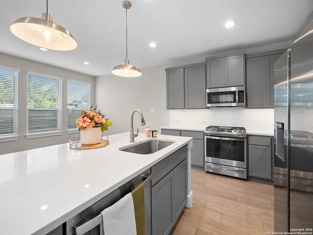 a kitchen with sink a stove and refrigerator