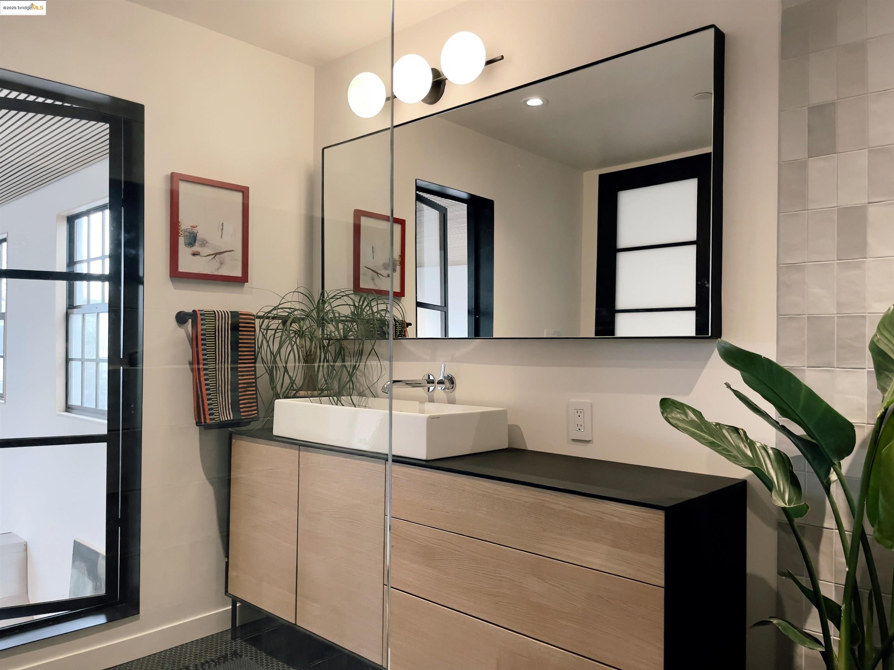 1818 Fifth Street Berkeley, CA 94710 - Photo 17 of 29 a bathroom with a sink and a mirror