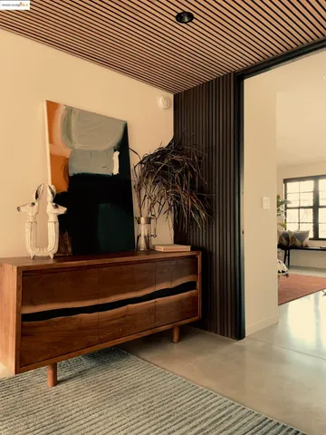 a living room with a couch and potted plant