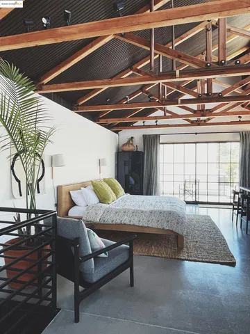 a view of a backyard with plants and outdoor seating