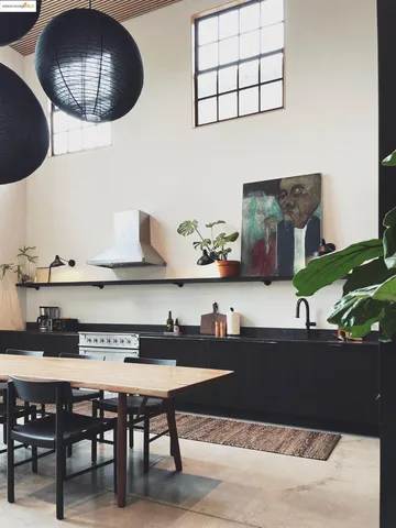 a living room with furniture and wall paintings