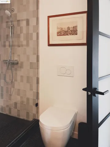 a bathroom with a toilet and a shower