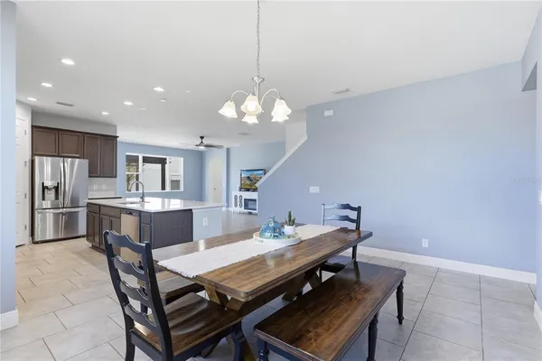a kitchen with stainless steel appliances granite countertop a sink a stove and a refrigerator