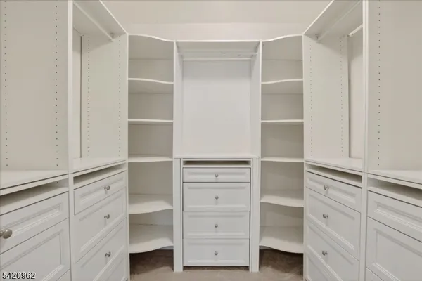 a bathroom with a bathtub shower sink vanity mirror and toilet