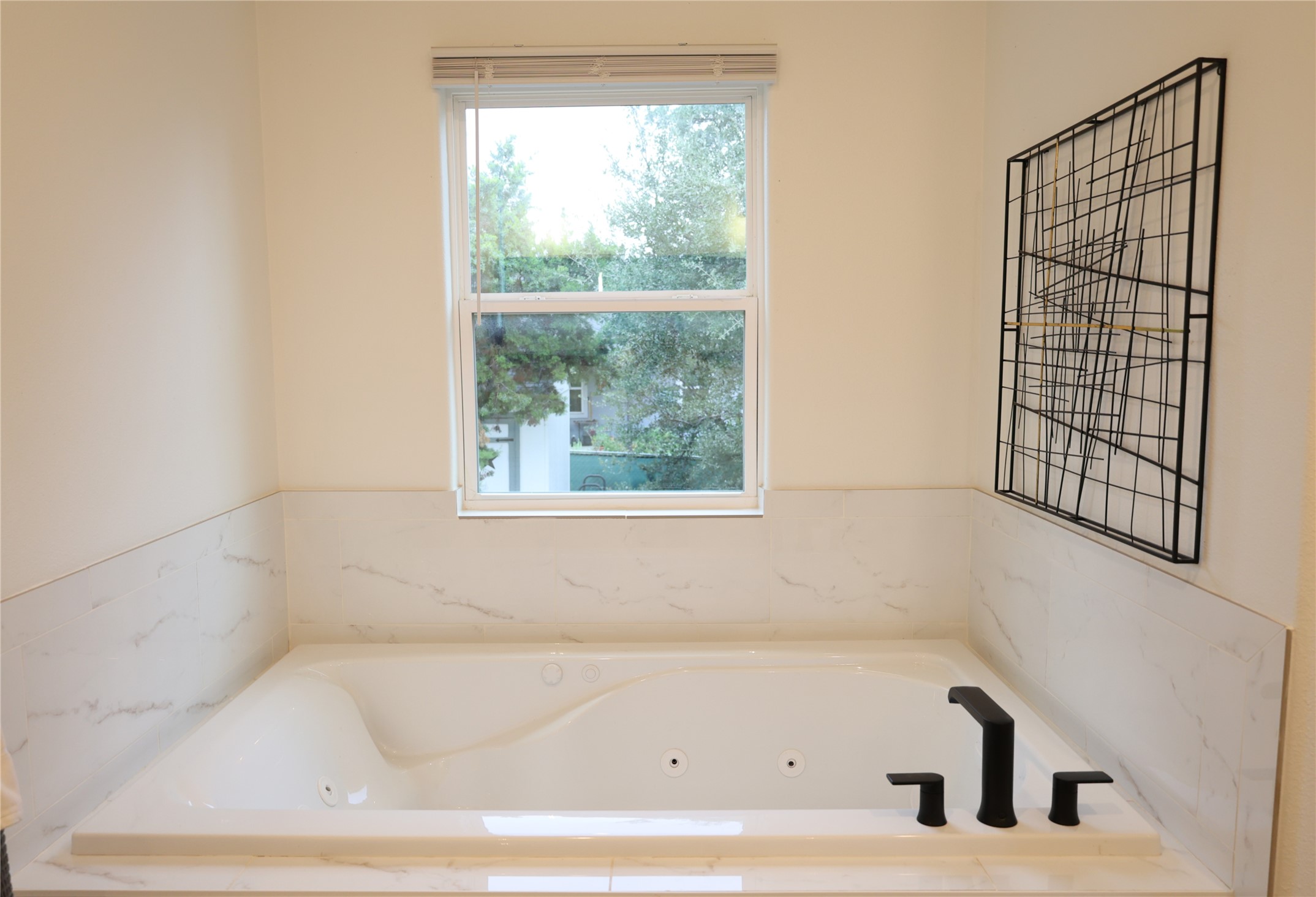 20602 Oak Ridge Lago Vista, TX 78645 - Photo 17 of 35 An inviting soaking tub rests beneath a window overlooking the garden.