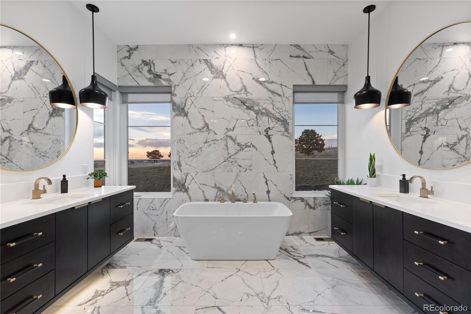 10689 Shadow Pines Road Parker, CO 80138 - Photo 25 of 50 a spacious bathroom with a double vanity sink mirror and bathtub