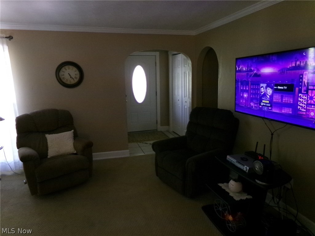 1912 Pickle Road Akron, OH 44312 - Photo 15 of 26 Living room featuring crown molding and light tile floors