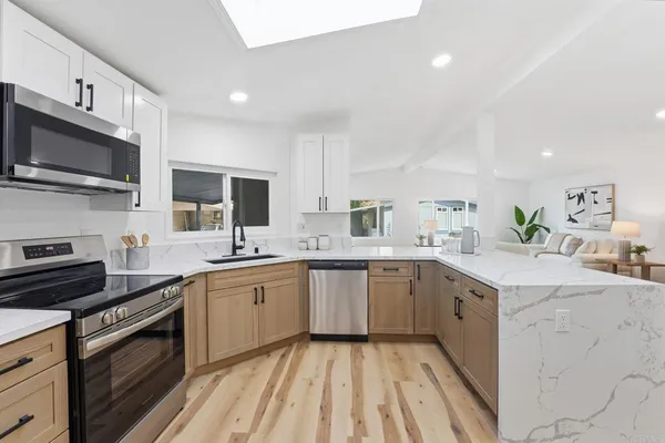 a kitchen with a sink stove and microwave