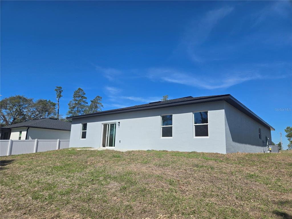 2644 Southwest 162nd Street Road Ocala, FL 34473 - Photo 4 of 47 a front view of a house with a yard