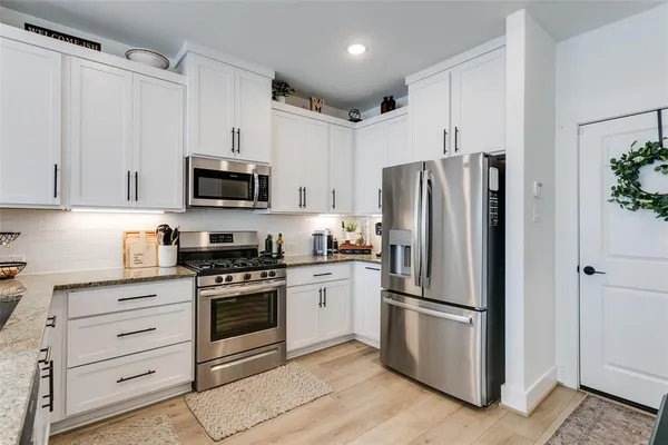 a kitchen with a sink a window and cabinets