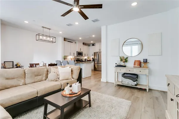 a living room with furniture a ceiling fan and a window