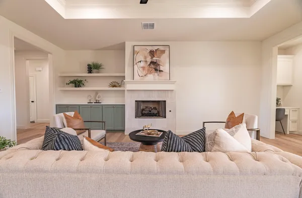 a living room with furniture a fireplace and a window