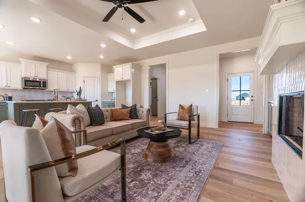 a living room with furniture and a wooden floor
