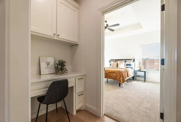 a bedroom with a bed and a chair with the view of bathroom