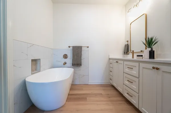 a bathroom with a white tub and sink