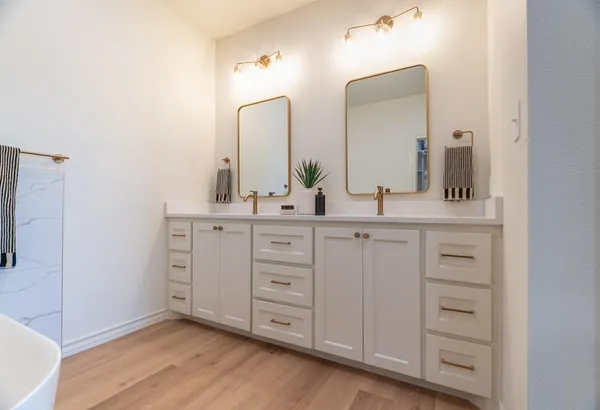 a bathroom with a double vanity sink and mirror