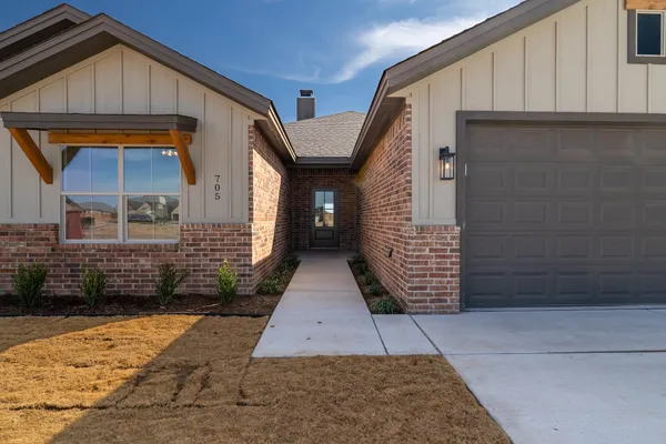 a view of front door of a house with a yard
