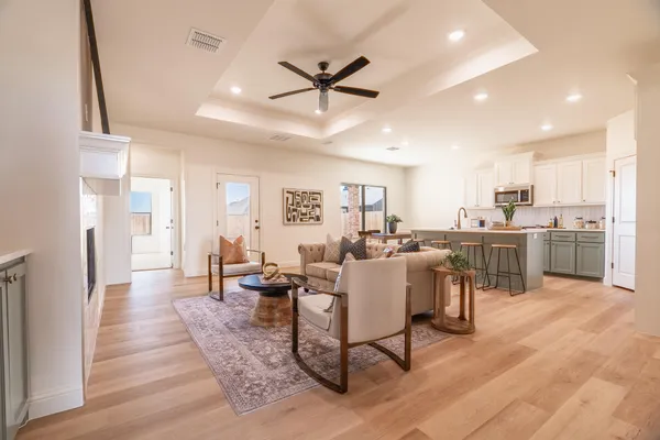a living room with lots of furniture and kitchen view