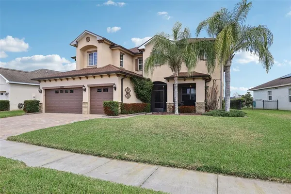 a front view of a house with a garden and yard